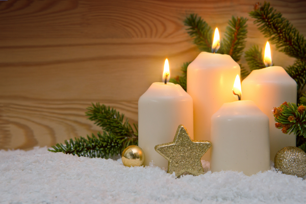 Four lit white candles to represent the season of Advent